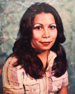 Photograph of a young Chicana woman with long, dark brown hair